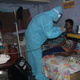 Asha warrior nebulising Covid positive patient at his home.